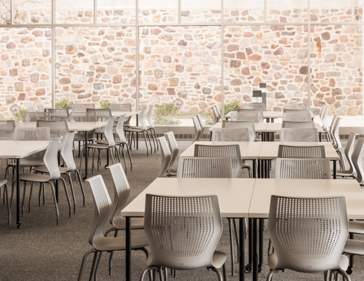 Knoll Antenna simple tables with black legs and MultiGeneration by Knoll chairs for a café